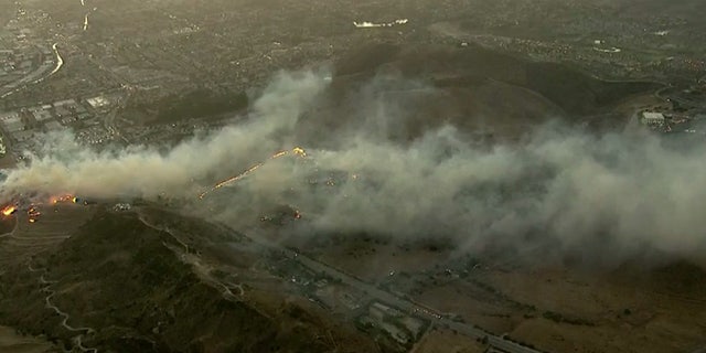 The Easy Fire broke out in Simi Valley, Calif. early Wednesday and was burning near the Ronald Reagan Presidential Library and Museum, seen to the right.