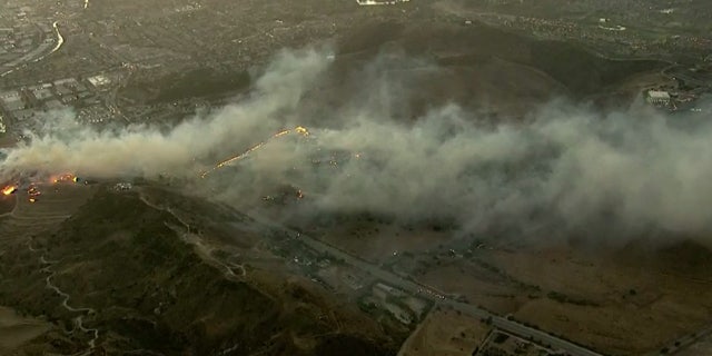 The Easy Fire broke out in Simi Valley, Calif. early Wednesday and was burning near the Ronald Reagan Presidential Library and Museum, seen to the right.