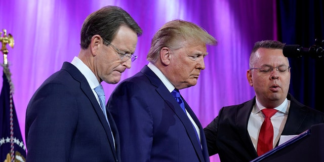 U.S. President Donald Trump prays between Tony Perkins, President of the Family Research Council, and Pastor Andrew Brunson (R) at the Family Research Council's annual gala in Washington, U.S., October 12, 2019. 