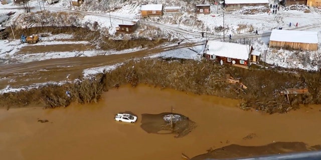 In this image made from video provided by Russian Emergency Situations Ministry press service, a view after the dam collapse during heavy rain on Saturday.