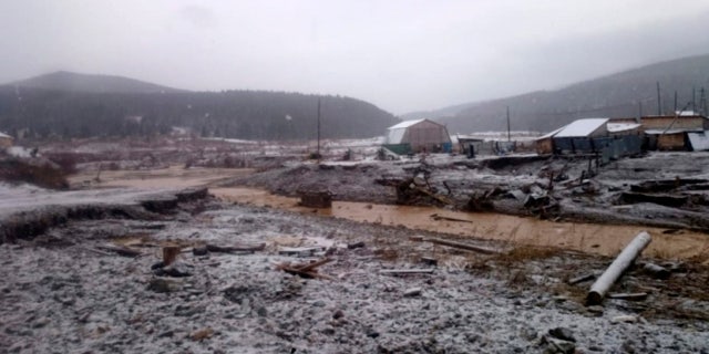 In this image made from video provided by Russian Emergency Situations Ministry press service, a view after the collapse of dam during heavy rain occurred near the village of Shchetinkino, on Saturday.