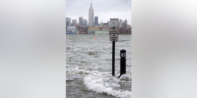 The Hudson River swells and rises over the banks of the Hoboken, N.J., waterfront as Hurricane Sandy approaches on Monday, Oct. 29, 2012. (AP Photo/Charles Sykes)