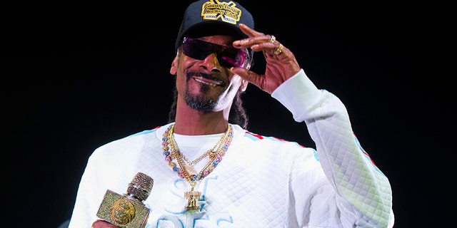 Snoop Dogg performs onstage at State Farm Arena in Atlanta. The University of Kansas has apologized for its risque Late Night at the Phog event in which the rapper performed, stripper poles were wheeled onto the Allen Fieldhouse floor and fake money was shot over the heads of prospective recruits. (Photo by Paul R. Giunta/Invision/AP, File)
