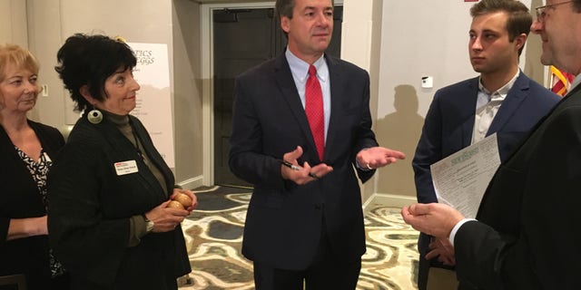 Former Democratic presidential candidate and current U.S. Senate candidate, Montana Gov. Steve Bullock mingles with the crowd after headlining the 'Politics and Eggs' speaking series, in Manchester, NH on Oct. 11, 2019