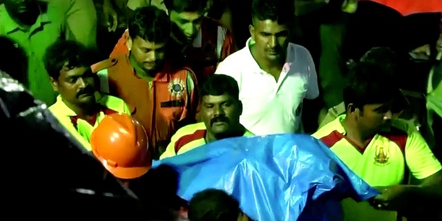 Search teams recover the body of Sujith Wilson, 2, after he fell down a well Friday.