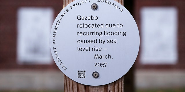 A sign, part of a public design installation by artist Thomas Starr, on a gazebo outside the University of New Hampshire boathouse in Durham, N.H., last week. (AP Photo/Charles Krupa)