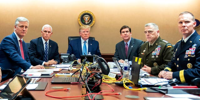 In this photo provided by the White House, President Donald Trump is joined by from left, national security adviser Robert O'Brien, Vice President Mike Pence, Defense Secretary mark Esper, Joint Chiefs Chairman Gen. Mark Milley and Brig. Gen. Marcus Evans, Deputy Director for Special Operations on the Joint Staff, Saturday, Oct. 26, 2019, in the Situation Room of the White House. (Shealah Craighead/The White House via AP)