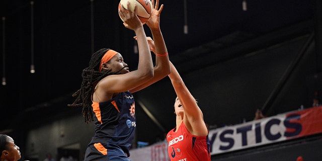 Connecticut Sun forward Jonquel Jones, left, goes to the basket against Washington Mystics forward Elena Delle Donne, right, in the first half of Game 2 of basketball's WNBA Finals, Tuesday, Oct. 1, 2019, in Washington. (AP Photo/Nick Wass)