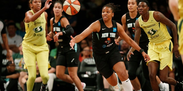 FILE - In this Aug. 11, 2019, file photo, New York Liberty guard Tanisha Wright, center, goes after a loose ball during the first half of the team's WNBA basketball game against the Seattle Storm at Barclays Center in New York. The Liberty will have a new home next year, playing their games at Barclays Center. (AP Photo/Kathy Willens, File)