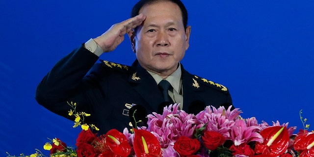 Chinese Defense Minister Wei Fenghe salutes after delivering his opening speech for the Xiangshan Forum, a gathering of the region's security officials, in Beijing, on Monday. Wei issued a stinging rebuke of the U.S. at a defense forum in Beijing, saying China wasn't fazed by sanctions, pressure and a