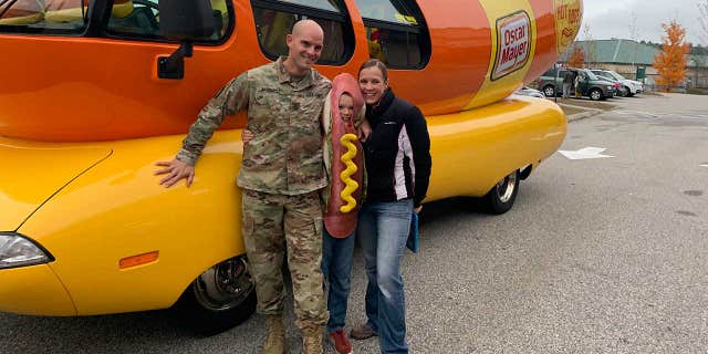 Jake, seen here with dad Craig and mom Kari, was treated to a ride in the famous Wienermobile on Monday.