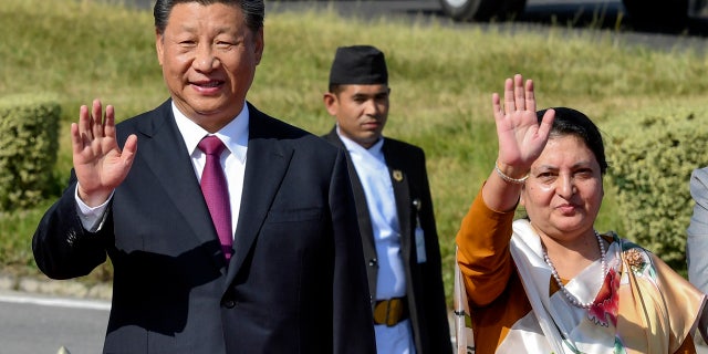 Chinese President Xi Jinping, center left waves with Nepal President Bidhya Devi Bhandari, as he bids farewell, wrapping up his two-day visit to Nepal in Kathmandu, Nepal, Sunday, Oct. 13, 2019.