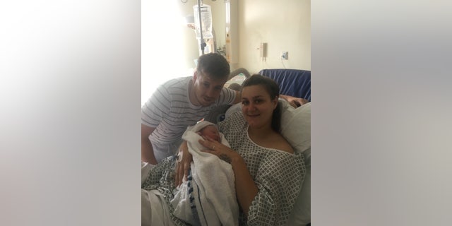 Ben Hayes, 28, with Callie Hayes, 22, holding newborn Teddy.