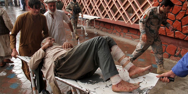 A wounded man is brought by stretcher into a hospital after an explosion at a mosque in Haskamena district of Jalalabad, east of Kabul, Afghanistan, on Friday.