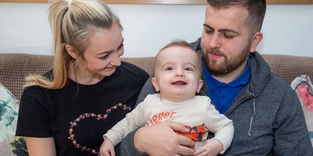 10-month-old Michael Labuschagne with his mom Emma and dad Stuart.