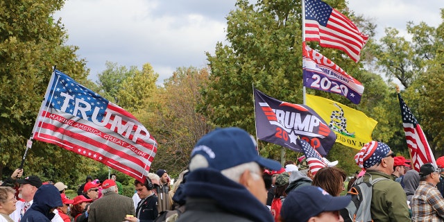 Pro-Trump flags ripple in the wind at the March for Trump rally Thursday. Rallygoers intended to send a message to Congress not to