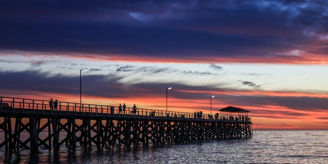 A dramatic sky with stunning colours during sunset over Grange beach in Adelaide (Amer Ghazzal/Barcroft Media via Getty Images)