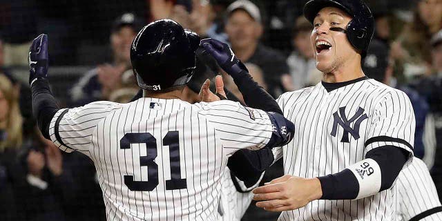 New York Yankees center fielder Aaron Hicks (31) celebrates with Aaron Judge after hitting a three-run home run against the Houston Astros during the first inning of Game 5 of baseball's American League Championship Series, Friday, Oct. 18, 2019, in New York. (Associated Press)
