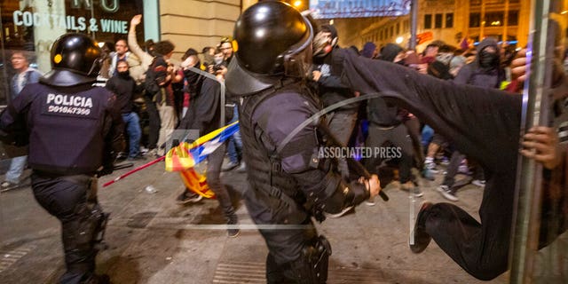 Protesters clash with police <br>
(AP Photo/Emilio Morenatti)