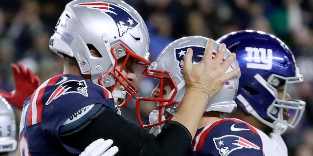 New England Patriots quarterback Tom Brady, left, celebrates his touchdown with Gunner Olszewski after scoring on a quarterback sneak in the second half of an NFL football game against the New York Giants, Thursday, Oct. 10, 2019, in Foxborough, Mass. (Associated Press)