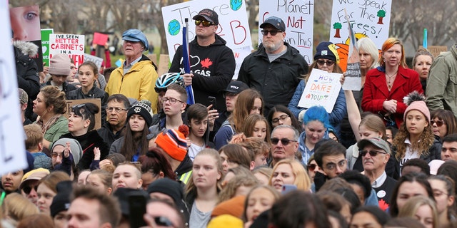 Climate change activists gather for a march and rally with Swedish climate activist Greta Thunberg at the Alberta Legislature Building in Edmonton, Alberta, on Friday, Oct. 18, 2019. (Dave Chidley/The Canadian Press via AP)