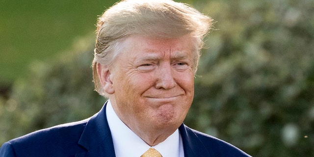 President Donald Trump smiles as he walks towards members of the media on the South Lawn of the White House in Washington, Friday, Oct. 11, 2019, before boarding Marine One for a short trip to Andrews Air Force Base, Md., and then on to Louisiana for a rally.