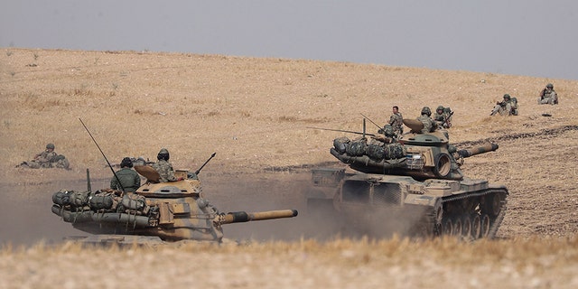 Turkish tanks and troops more near Syrian town of Manbij, Syria, on Tuesday, October 15, 2019. (AP/DHA)