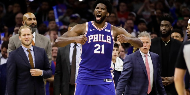 Philadelphia 76ers' Joel Embiid reacts after it was announced that he and Minnesota Timberwolves' Karl-Anthony Towns were ejected, during the second half of an NBA basketball game Wednesday, Oct. 30, 2019, in Philadelphia. The 76ers won 117-95.