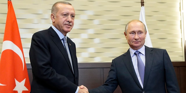 Russian President Vladimir Putin, right, and Turkish President Recep Tayyip Erdogan shake hands during their meeting Tuesday in the Black Sea resort of Sochi, Russia. (AP)