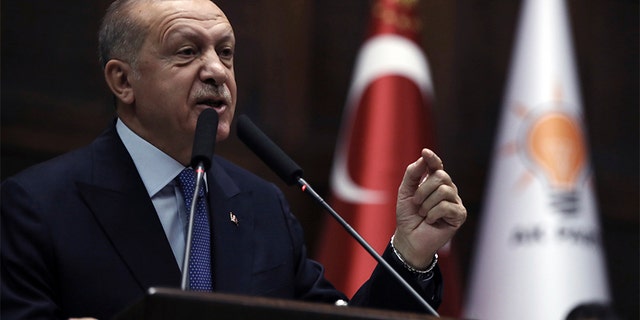 Turkish President Recep Tayyip Erdogan addresses his ruling party legislators at the Parliament, in Ankara, on Wednesday, October 16, 2019.