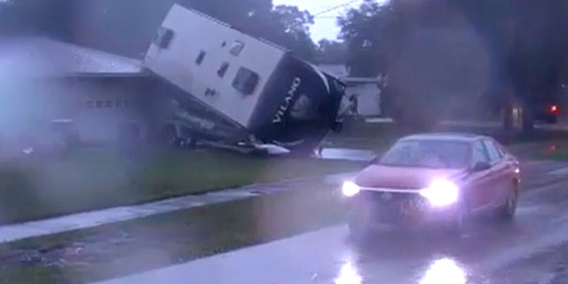 RV was seen blown on top of a boat in a driveway in Polk County down the street from Kathleen Middle School