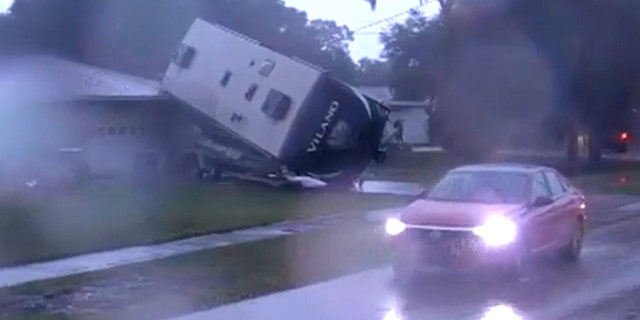 RV was seen blown on top of a boat in a driveway in Polk County down the street from Kathleen Middle School