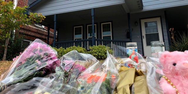 Bouquets of flowers and pressed animals pier adult outward a Fort Worth home on Monday, where a 28-year-old black lady was shot and killed by a white military officer.