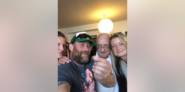 Dan Levine poses with his wedding ring alongside Gary and Emma Spiers, who stumbled upon the missing keepsake by chance.