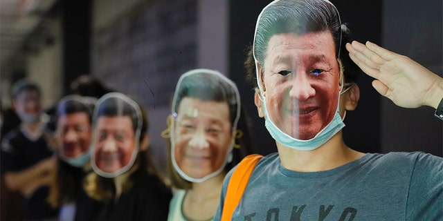 Protesters wear masks of Chinese President Xi Jinping in Hong Kong on Friday.
