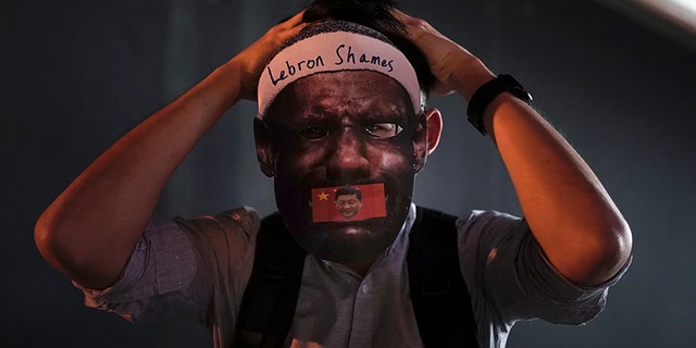 A protester wears a mask of LeBron James during a demonstration in Hong Kong on Friday. (AP)