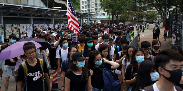 Students march to the Chinese University to show support to those students who were arrested by police in Hong Kong, on Thursday. (AP)