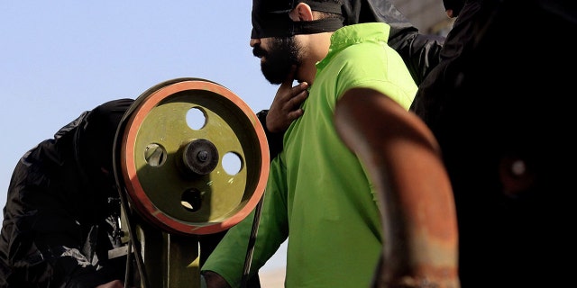 Authorities carry out the court-ordered amputation of the fingers of a convicted thief in a public square in the southern Iranian city of Shiraz, Thursday, Jan. 24, 2013.
