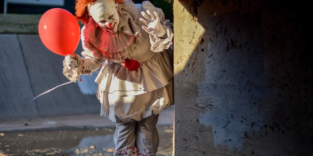 Maci Ann Tate dressed up as the clown Pennywise from the movie, while her boyfriend Jonathan dressed up as character Georgie.