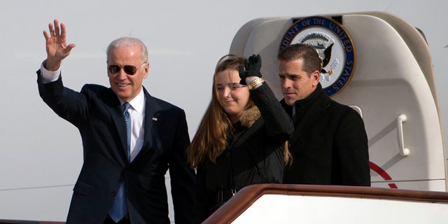 U.S. Vice President Joe Biden (L) waves as he walks out of Air Force Two with his granddaughter Finnegan Biden and son Hunter Biden at the airport in Beijing December 4, 2013. The younger Biden's business dealings are coming under scrutiny as House Democrats push forward with an impeachment inquiry into President Trump for allegedly pressuring the Ukranian President to investigate the Biden family for political gain.