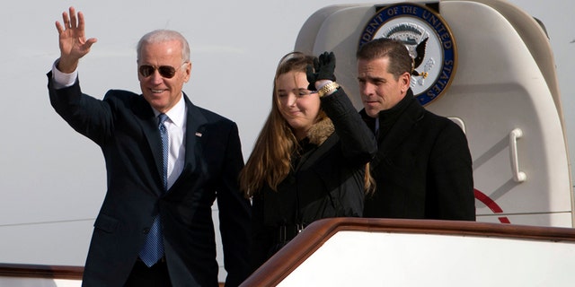 U.S. Vice President Joe Biden (L) waves as he walks out of Air Force Two with his granddaughter Finnegan Biden and son Hunter Biden at the airport in Beijing December 4, 2013. The younger Biden's business dealings are coming under scrutiny as House Democrats push forward with an impeachment inquiry into President Trump for allegedly pressuring the Ukranian President to investigate the Biden family for political gain.