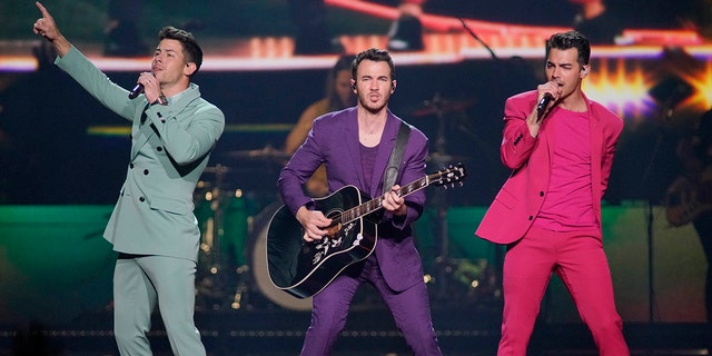 Nick Jonas, Kevin Jonas, and Joe Jonas, of the Jonas Brothers, performing during their "Happiness Begins Tour" in Chicago. 