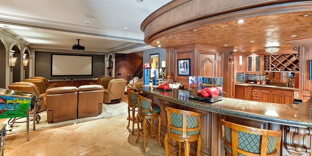 The property includes a media/game room complete with a sit-down bar area.