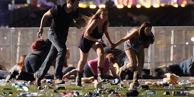 People run from the Route 91 Harvest country music festival after apparent gun fire was hear on October 1, 2017 in Las Vegas, Nevada.