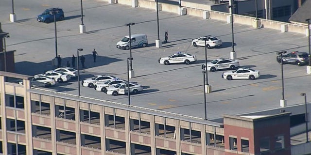 Police officers swarm the Silver Spring parking garage where Bomba was found. 