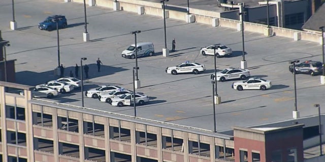 Police officers swarm the Silver Spring parking garage where Bomba was found.