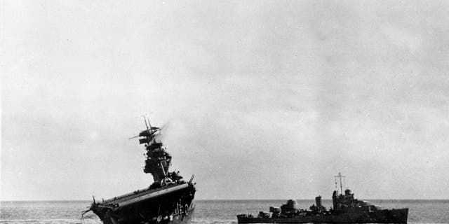 FILE - In this June 4, 1942 file photo provided by the U.S. Navy shows the USS Yorktown listing heavily to port after being struck by Japanese bombers and torpedo planes in the Battle of Midway. Researchers scouring the world's oceans for sunken World War II ships are honing in on debris fields deep in the Pacific.(AP Photo/U.S. Navy, File)