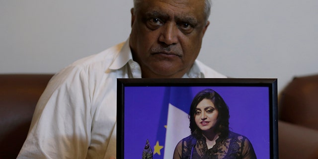 Mohammad Ismail, father of Pakistani human rights activist Gulalai Ismail, holds a picture of his daughter as he poses for a photo in his home in Islamabad, Pakistan, last Thursday.