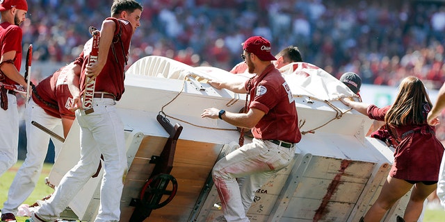 A crew helped pull up the Oklahoma Sooner Schooner, which flipped over during a touchdown celebration on Saturday. (AP Photo/Alonzo Adams)