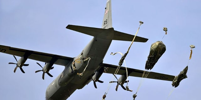 U.S. paratroopers conduct an airborne operation from a C-130 Hercules aircraft on Juliet Drop Zone near Pordenone, Italy, Sept. 24, 2014.